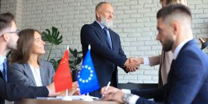 European Union and Chinese leaders shaking hands on a deal agreement